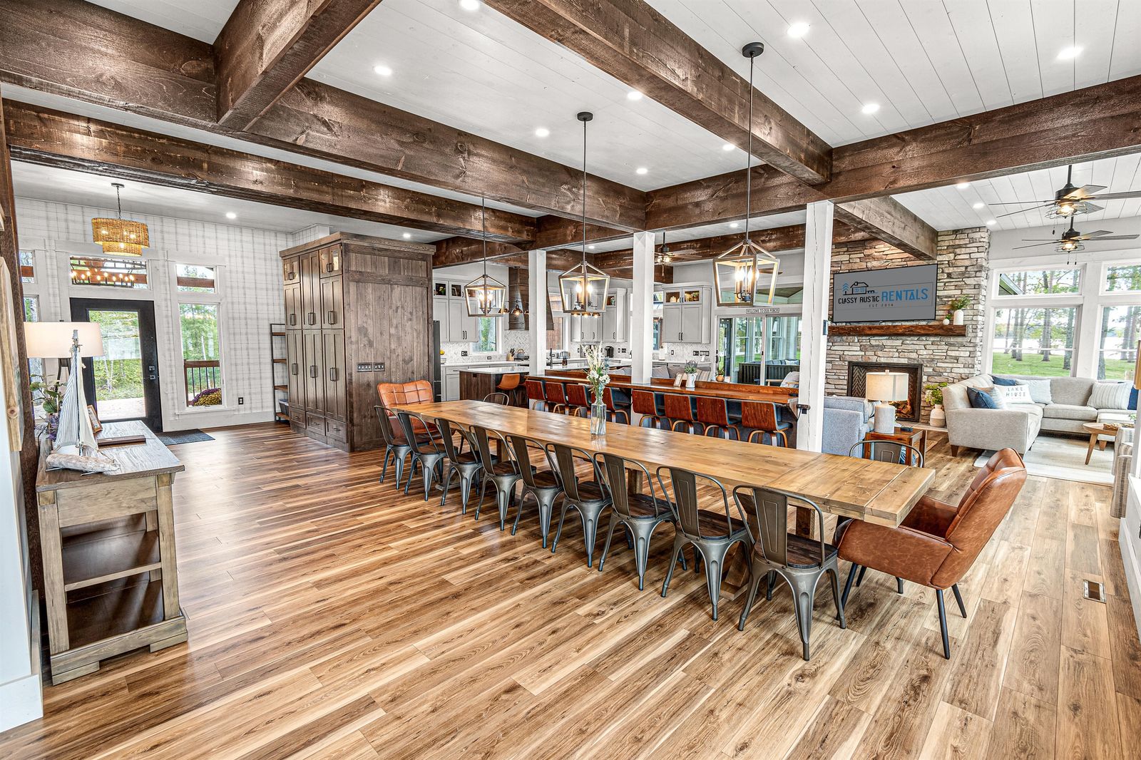 A long dining table set for a large family gathering under timber beams